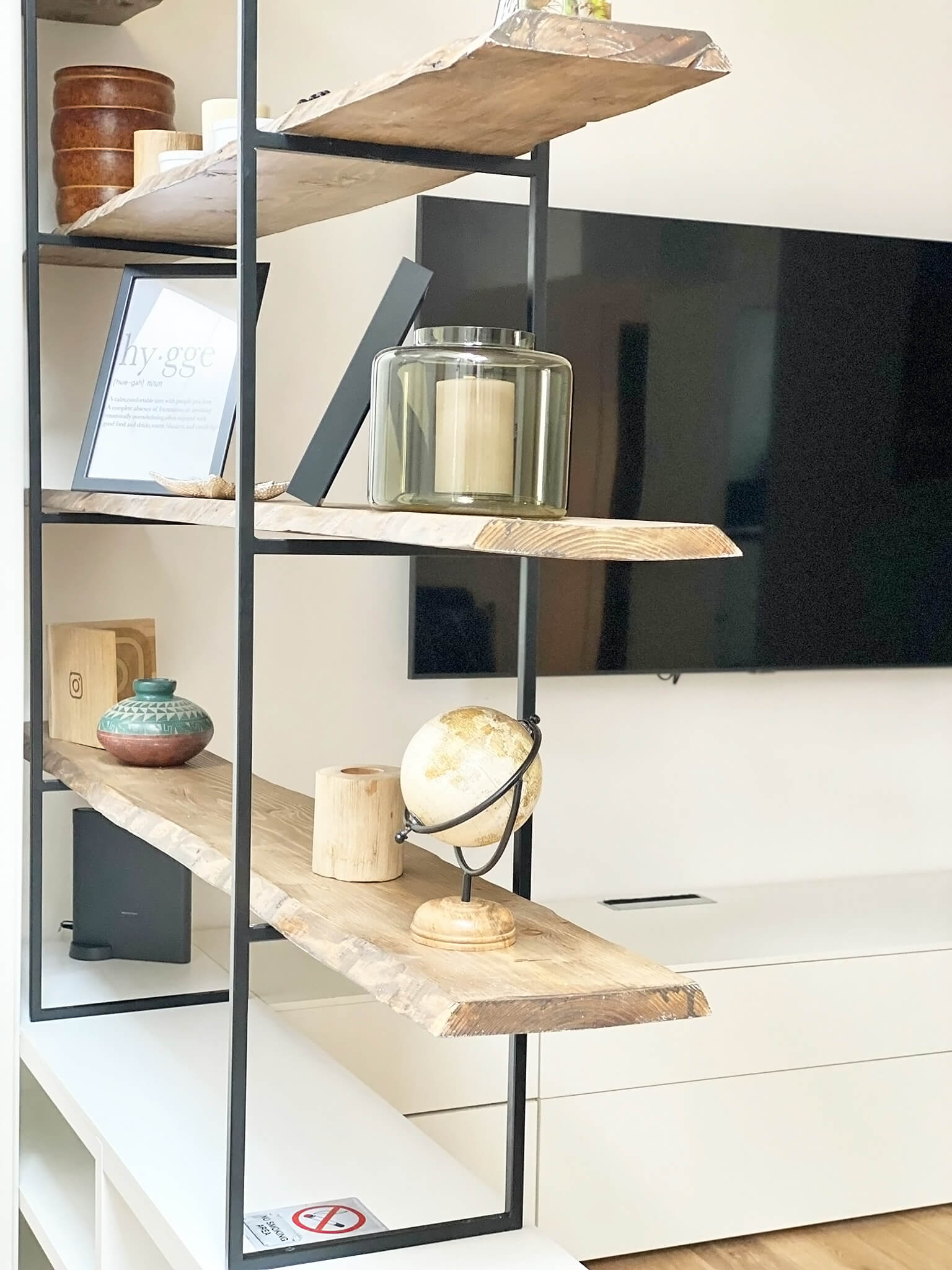 Raw wood shelves on a thin black metal structure
